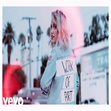 Image of Britt Nicole turning back to camera with "Work of Art" written on the back of her shirt with pink colour around her hair - My Christian Musician