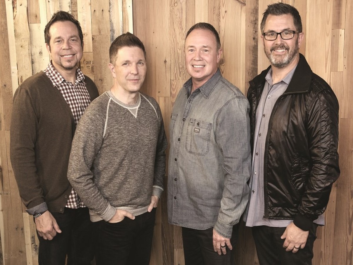 Award Winning Christian Musician Singers 4Him Standing in front of wooden wall