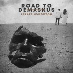 Contemporary Christian Musician Israel Houghton's Road to DemaskUs album covero showing a damaged mask and a man and woman walking away