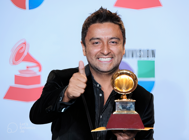 Alex Campos doing a thumbs up gesture while holding a Grammy Award - My Christian Musician
