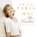 Twila Paris looking away, and a text on the left that displays " TWILA PARIS, He is Exalted, LIVE WORSHIP" - My Christian Musician