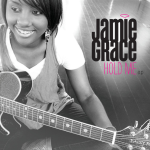 Jamie Grace sitting while holding her guitar, and a text displaying "JAMIE GRACE, HOLD ME e.p." - My Christian Musician