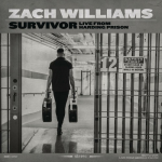 Zach Williams carrying two guitar cases while walking in a prison hallway - My Christian Musician