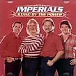 Group photo of The Imperials wearing red clothing with a text above that displays "IMPERIALS, STAND BY THE POWER" - My Christian Musician