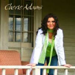Cheri Adams leaning forward on a house balcony - My Christian Musician