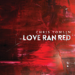 Canvas painted with red paint with a text overlay that says "CHRIS TOMLIN, LOVE RAN RED" - My Christian Musician