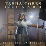 Tasha Cobbs holding a microphone with arms wide open as a cover art for her song "Your Spirit" - My Christian Musician
