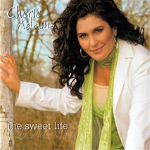 Cheri Adams poses in front of a camera with one hand placed on a tree, with a text overlay that says "cherie adams the sweet life" - My Christian Musician